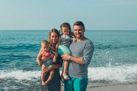 family sittingl on the sand. girl on the beach. Summer vacation by the sea. Travel to hot countriesの写真素材