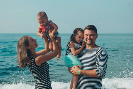 family sittingl on the sand. girl on the beach. Summer vacation by the sea. Travel to hot countriesの写真素材
