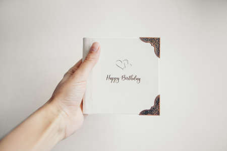 A white book wrapped in leather on a white background. photo album with a metal frame. Greeting cardの写真素材