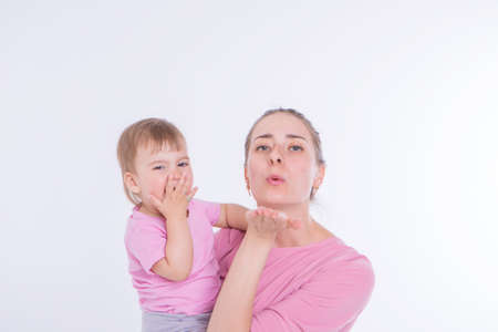 the concept of a healthy lifestyle, the protection of children, shopping - baby in the arms of the mother. Woman holding a child. air kissの写真素材