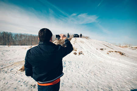 BMW advertising, Moscow, 1.11.2018: demonstration of a model of a black car, cars on a snow-covered road, advertising shootingのeditorial素材