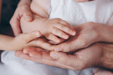 Newborn Babys hand. Mother and father holding newborn baby armの写真素材