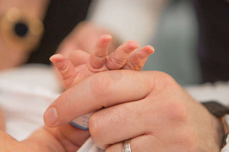 Newborn Baby's hand. Mother and father holding newborn baby armの写真素材