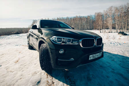 BMW advertising, Moscow, 1.11.2018: demonstration of a model of a black car, cars on a snow-covered...