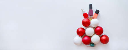 Nail polishes and a Christmas tree made of decorative balls. New year's shopping. Visiting a beauty...
