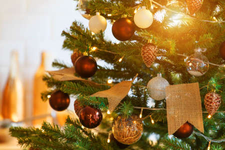 holidays, new year, decor and celebration concept - close up of christmas tree decorated with balls...