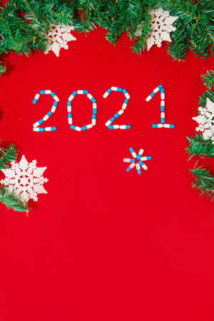 Christmas decorations and medical devices: syringe. Copy space on a red backgroundの写真素材