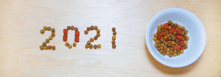 food for cats and dogs and the new year. Dry food label. Pet treats in 2021の写真素材