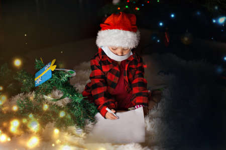 a child in red clothes and medical mask is sitting waiting for the new year. the concept of...