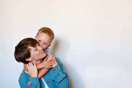 mother's day. mother's love. A happy mom with son in blue cloth embrace. Isolated on a white background. copy space. Game with childの写真素材