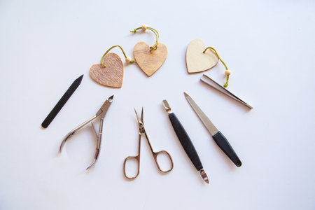 Nail accessories and hearts for Valentine's Day. Purchase of manicure products. manicure set for February 14. Visiting a beauty salon during the holidays. isolated on a white backgroundの写真素材