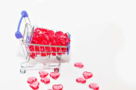 Valentine's day, endless love or special occasion concept: Top view of red hearts spilled out of a shopping cart. isolated on white background. copy space.の写真素材