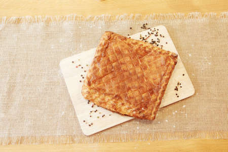 Pie on a chopping board. The food is ready to eat. Puff pastry pastryの写真素材