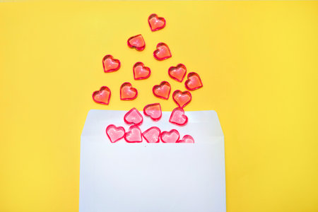 Happy Valentine's Day, flatley. Top view hearts spilled out of the envelope on the yellow background color of 2021. Greeting card for Valentine's Day or New Year. Pantone colorsの写真素材