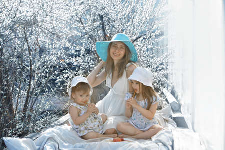 a happy family walks through a flower meadow. Love and spring blooming. Mother with daughter celebrities a 8 Marchの写真素材