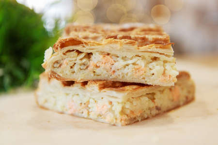 Chicken and potato pie on the dining table. The food is ready to eat. Puff pastry. kitchen utensils for cookingの写真素材