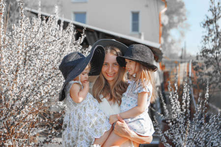 a happy family walks through a flower meadow. Love and spring blooming. Mother with daughter celebrities a 8 Marchの写真素材