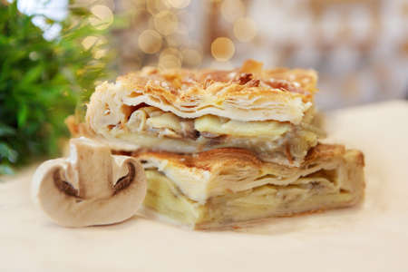 Chicken and potato pie on the dining table. The food is ready to eat. Puff pastry. kitchen utensils for cookingの写真素材