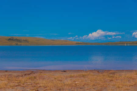the concept of weather observation, meteorology. wind and small waves. Landscape by the river and sandy beachの写真素材