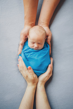 portrait of newborn baby lying on the hands of parentsの写真素材