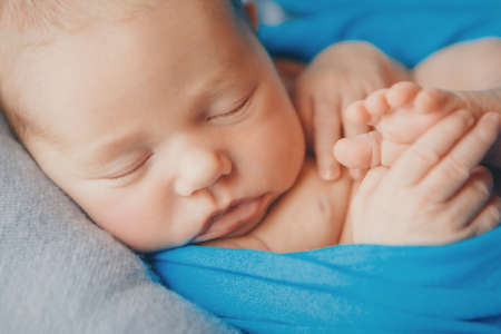 Portrait of newborn baby on a white background.