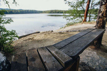 the concept of weather observation, meteorology. wind and small waves. Landscape by the river, trees and sandy beachの写真素材