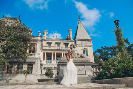 young beautiful girl in summer dress. Travels around the European city in the summer. Cheerful,...