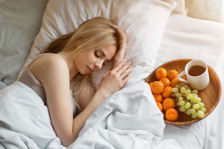 morning girls: the blonde is sleeping. breakfast in bed. I just woke up. fruit on a plate