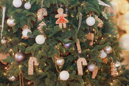holidays, new year, decor and celebration concept - close up of christmas tree decorated with balls...