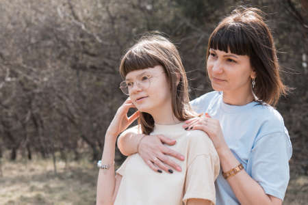 two happy girls smiling. Portrait of women hugging. The concept of relationships in the family, friends, sisters, couple in loveの写真素材