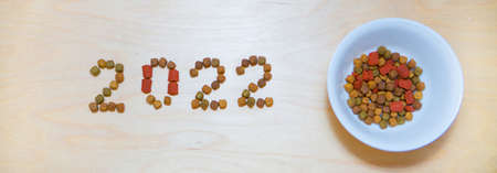 food for cats and dogs and the new year. Dry food label. Pet treats in 2022の写真素材