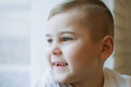 Portrait of baby with big eyes. Face of small child. smiling caucasian boyの写真素材
