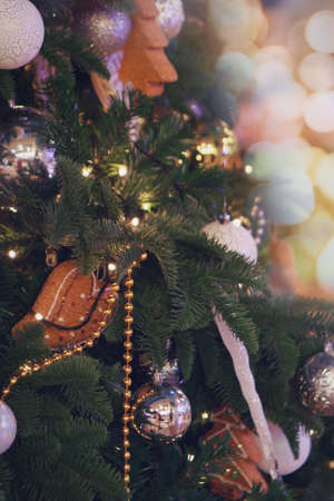holidays, new year, decor and celebration concept - close up of christmas tree decorated with balls and toysの写真素材