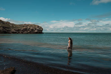 girl with long hair posing in water. treavel by the seaの写真素材