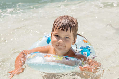 a girl in an inflatable circle for swimming on vacation in the pool, the sea. Spa concept, swimming...