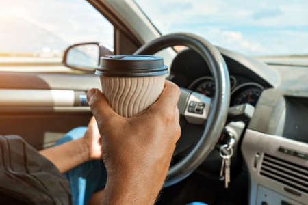 morning on the road: a cup of tea, coffee in a disposable cup. I just woke up.の写真素材