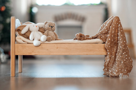 Baby bed with toys on the background of a Christmas tree and a fireplace. Christmas background. Childrens holiday. waiting for santa claus. High quality photoの写真素材