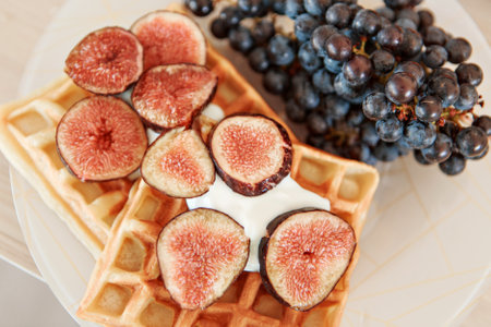Viennese waffles with figs and black grapes at home and in the restaurant. Healthy healthy breakfast...