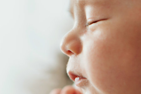 A newborn baby in diapers. A baby in the hands of a mother, maternal love, family, childbirth, having many children. Childrens clothes, booties.の写真素材