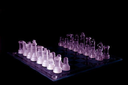 Crystal chess pieces on a row .On black backgroundの写真素材