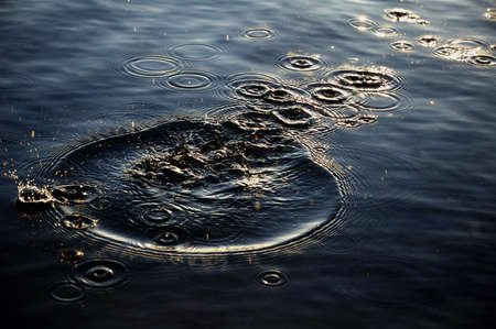 Water splashes in dark tones ,shooted on sunrice lightの写真素材