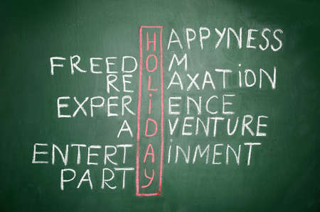 Holiday   and other related words, handwritten in crossword on green blackboard の写真素材