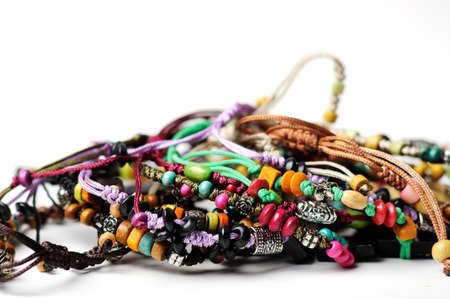 Heap of glass bead accessories on white  Homemade jewelry の写真素材