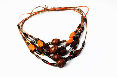 Beautiful wooden  necklaces  closeup on white backgroundの写真素材
