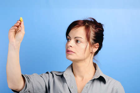female writing something on glass board with chalkの写真素材