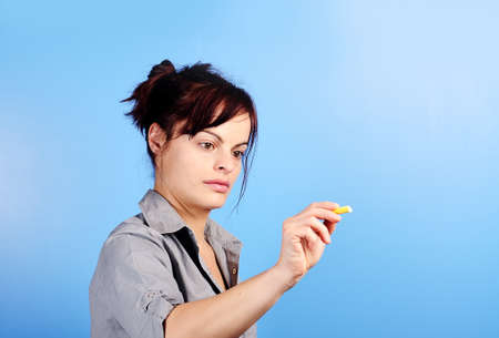 female writing something on glass board with chalkの写真素材