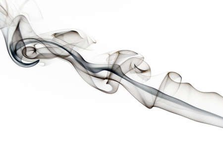Abstract black smoke swirls over white background の写真素材