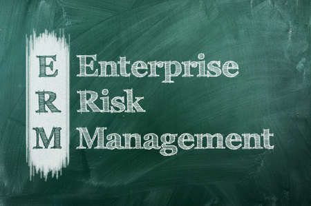 acronym erm - enterprise risk management on green chalkboardの写真素材