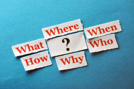 questions on cut paper on blue background close upの写真素材