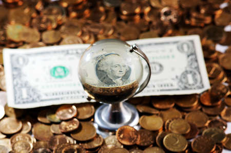 Glass globe and reflection of   dollar bill and  pile of coins